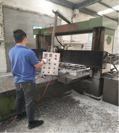 Operator at a CNC gantry mill machining a mold body