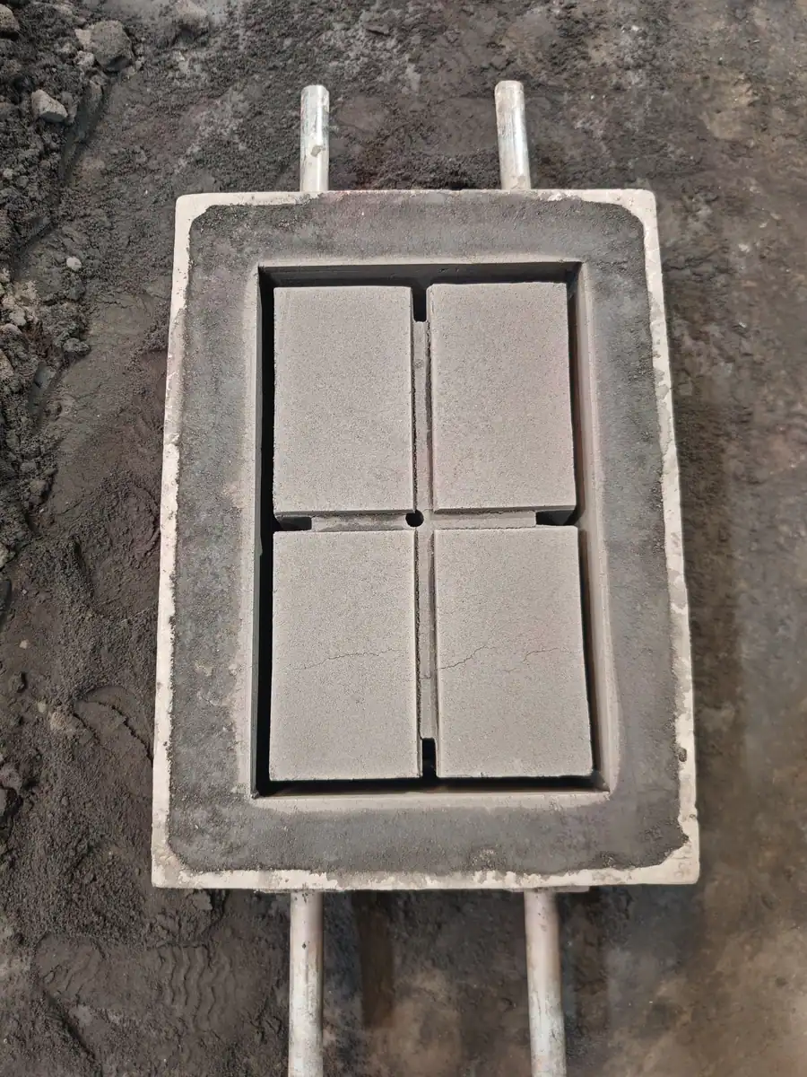 Close-up of a four-cavity sand mold made on site